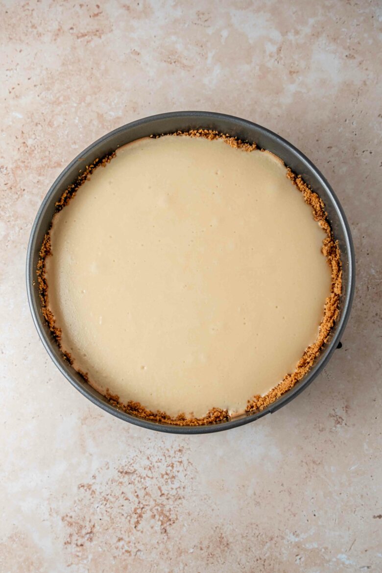 Baked white chocolate cheesecake in springform pan.