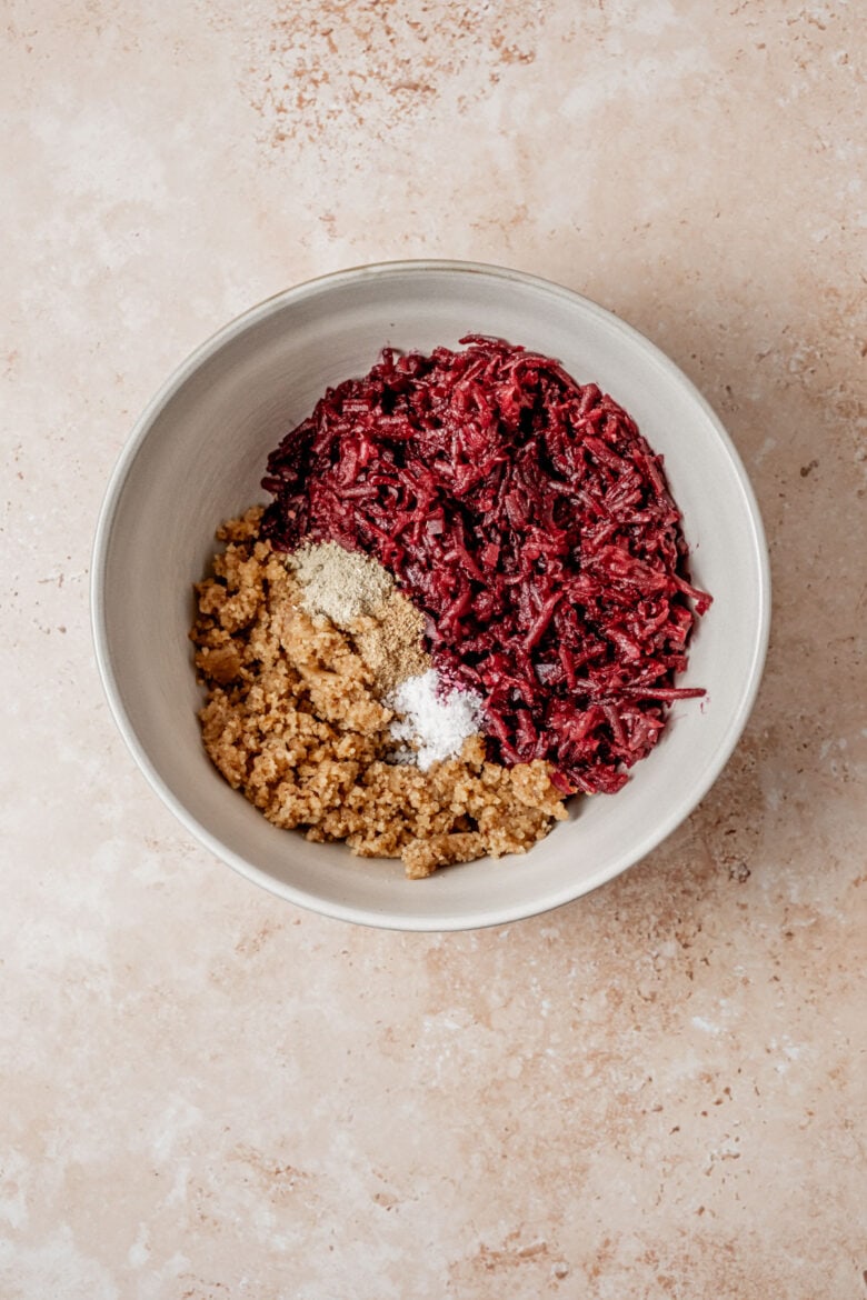 Shredded beets, walnut paste and spices in mixing bowl.
