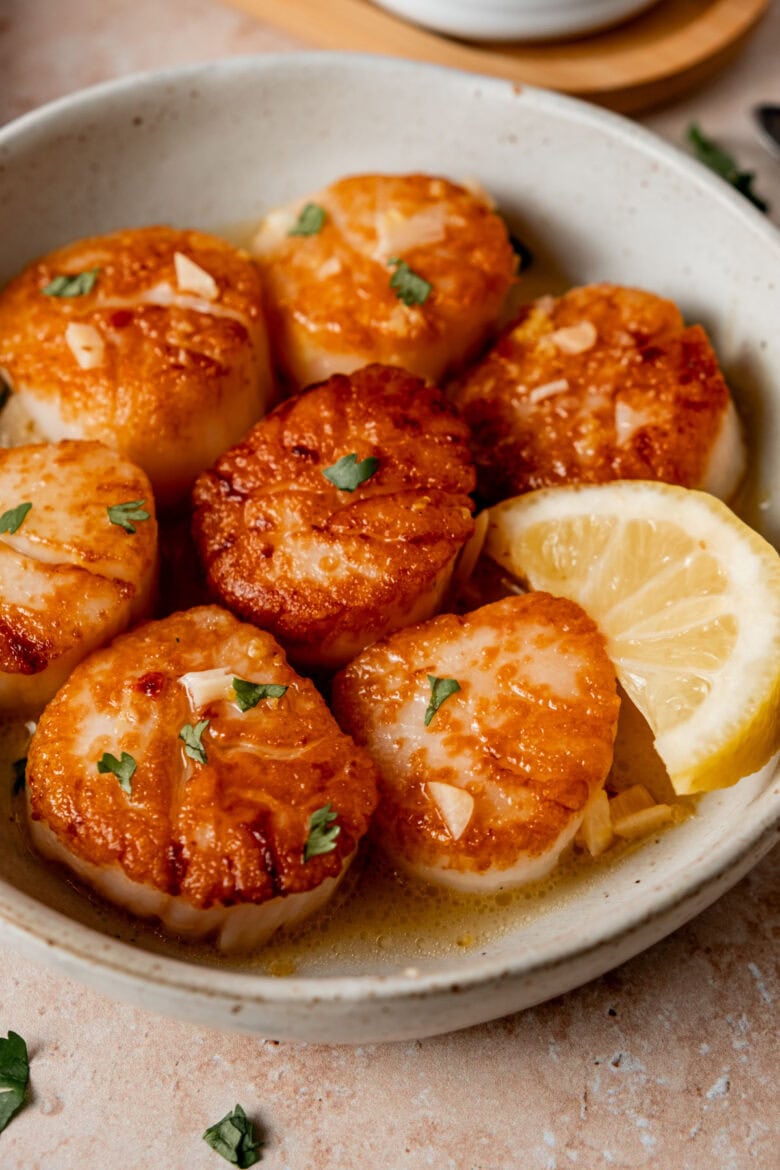 Golden brown scallops on plate.