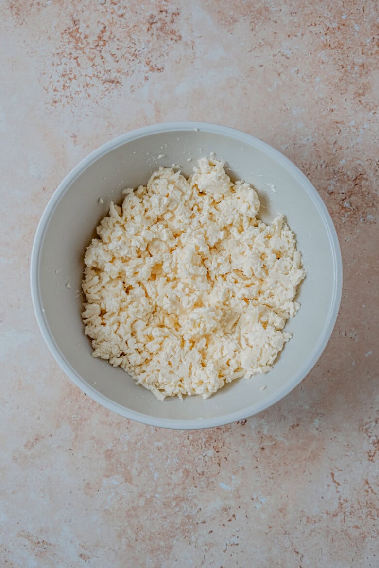 Mixture of three cheeses in bowl.