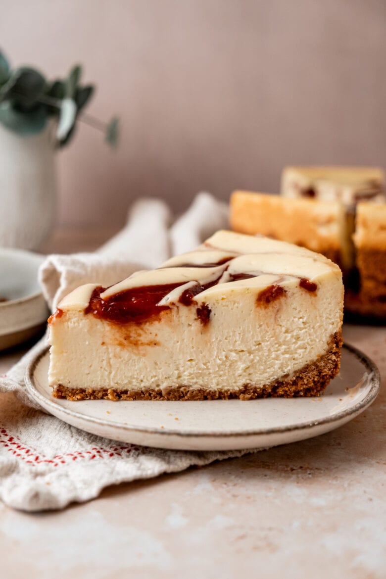 Slice of velvety smooth cheesecake on a plate.