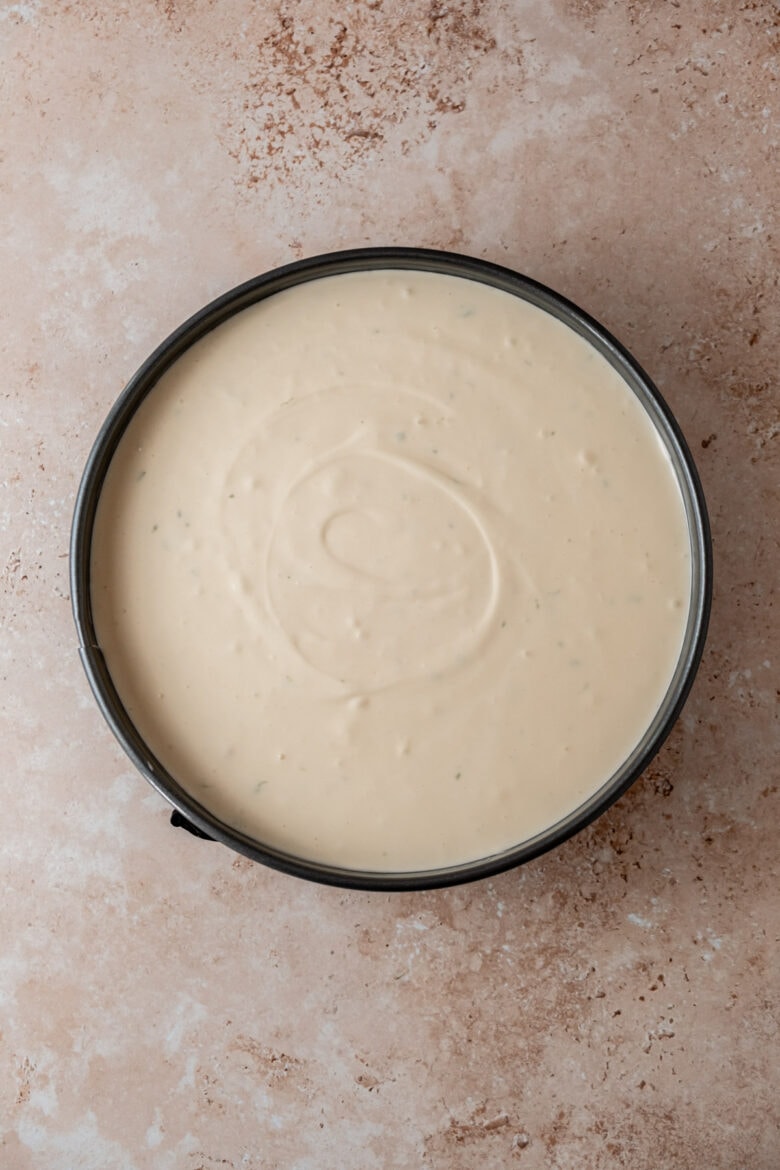 Cheesecake in springform pan before adding guava swirl.
