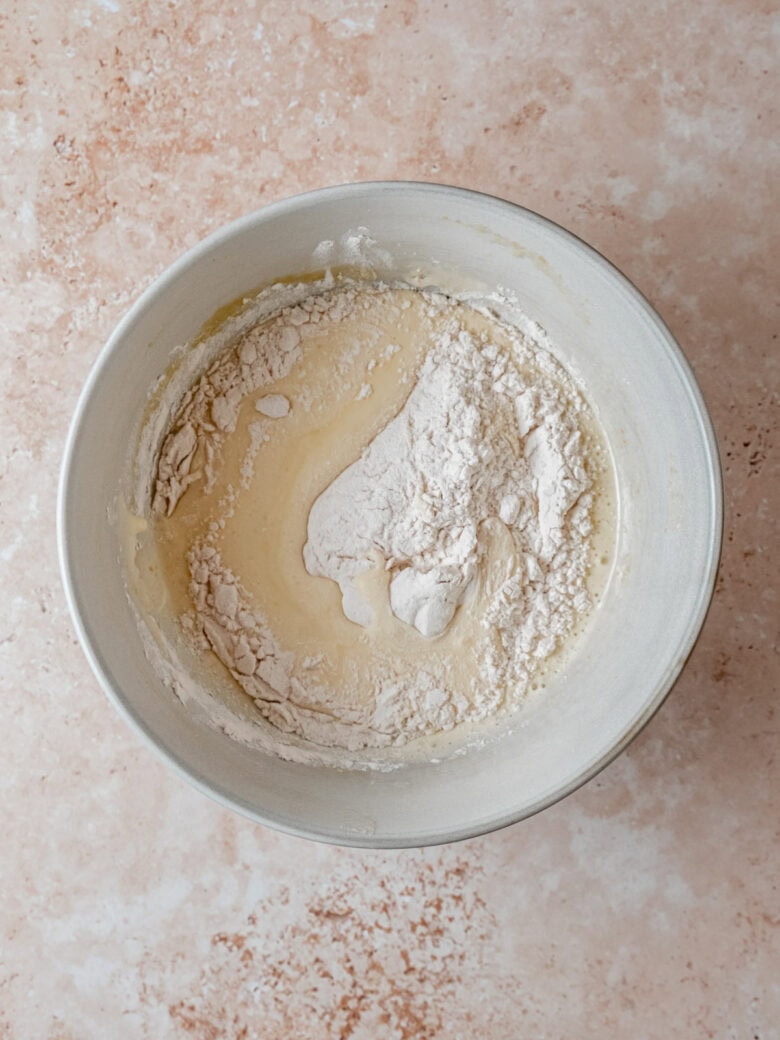 Folding flour into egg mixture.
