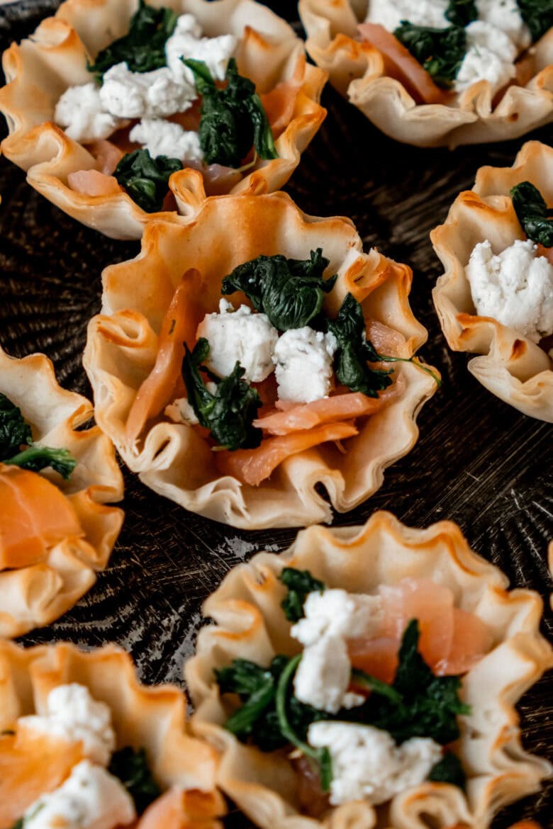 Goat cheese crumbles, smoked salmon and spinach in phyllo cup before adding topping.