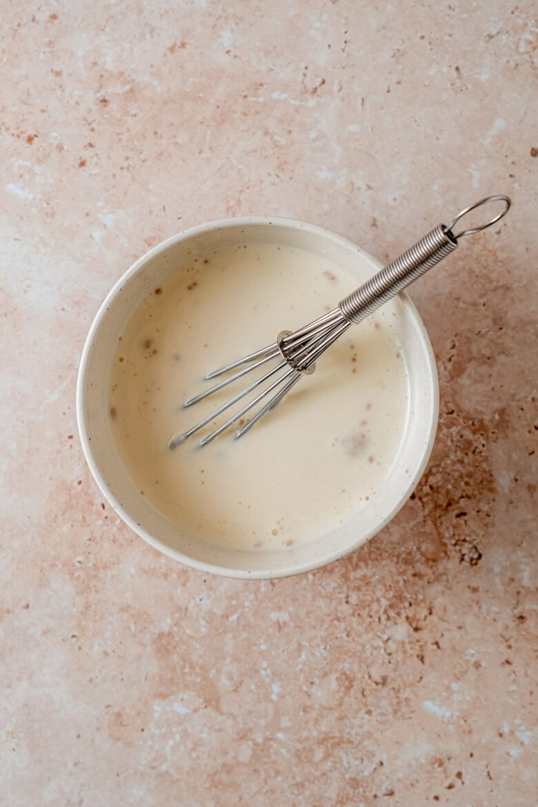 Whisking heavy cream and egg in small bowl.