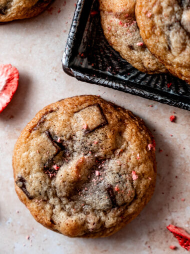 Close up of chocolate chunk cookie with strawberries.