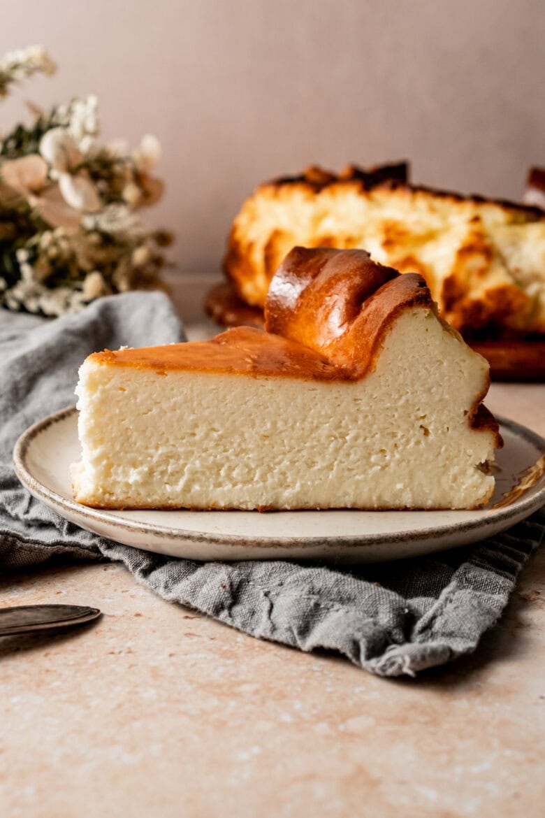 Slice of fluffy cheesecake with caramelized top.