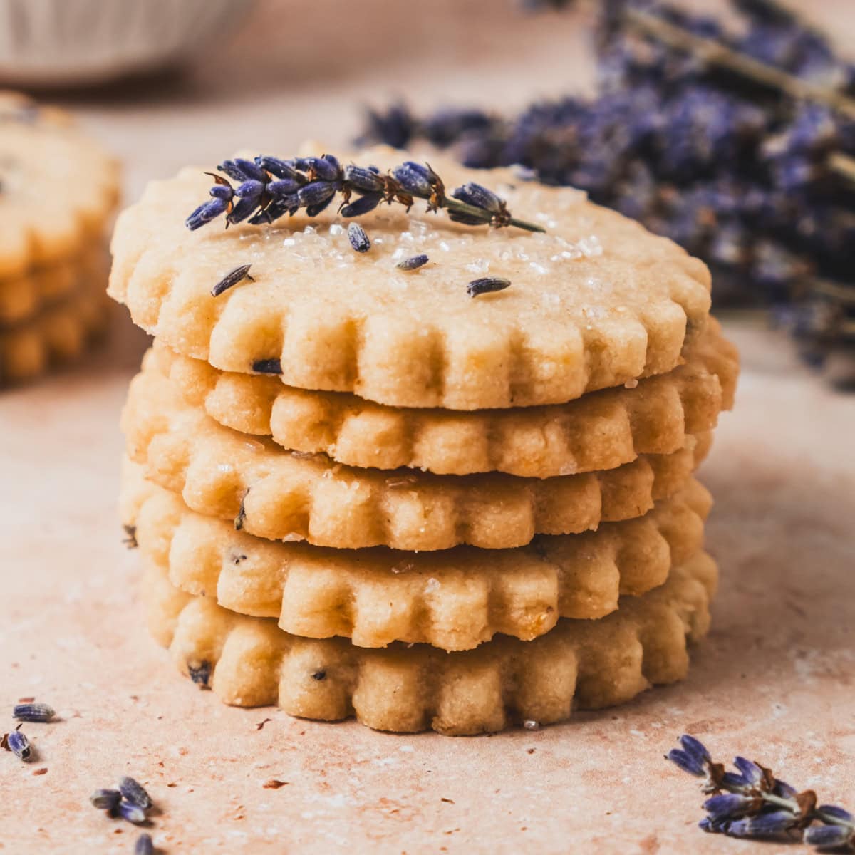 Stack of shortbread cookies topped with sprig of lavender.