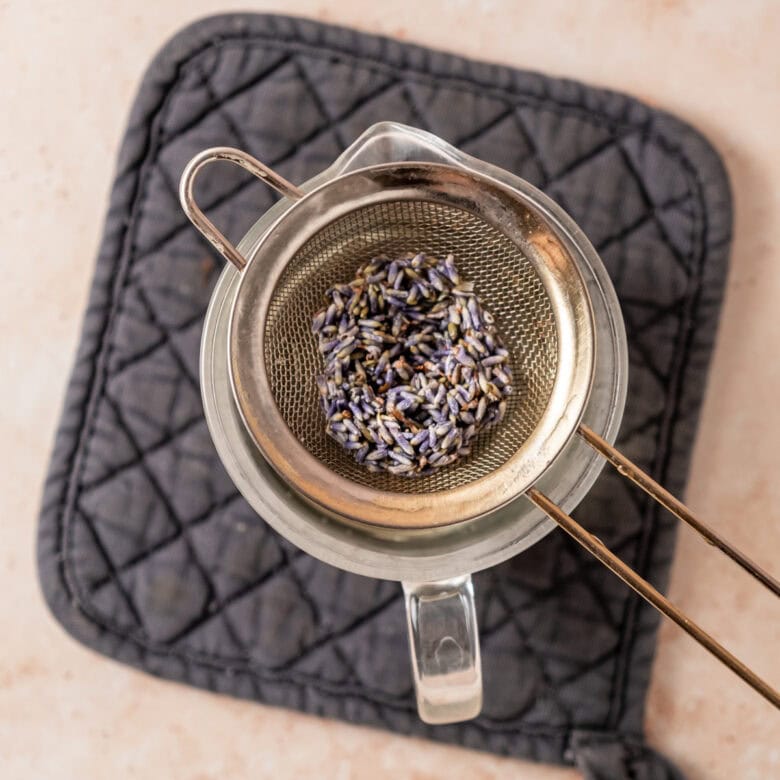 Lavender buds in mesh sieve.